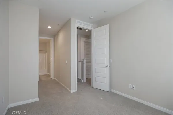 an empty room with closet and a bathroom