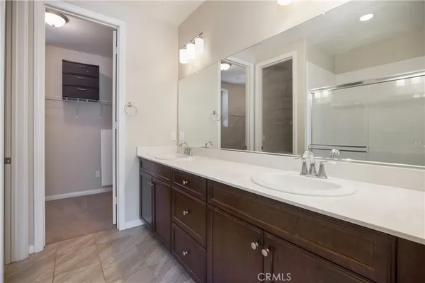 a bathroom with a double vanity sink and a mirror