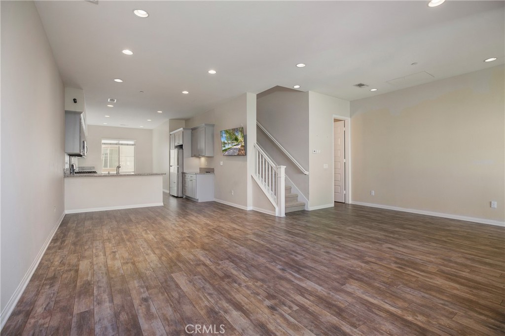 116 Neptune Irvine, CA 92618 - Photo 8 of 25 a view of empty room with wooden floor and kitchen