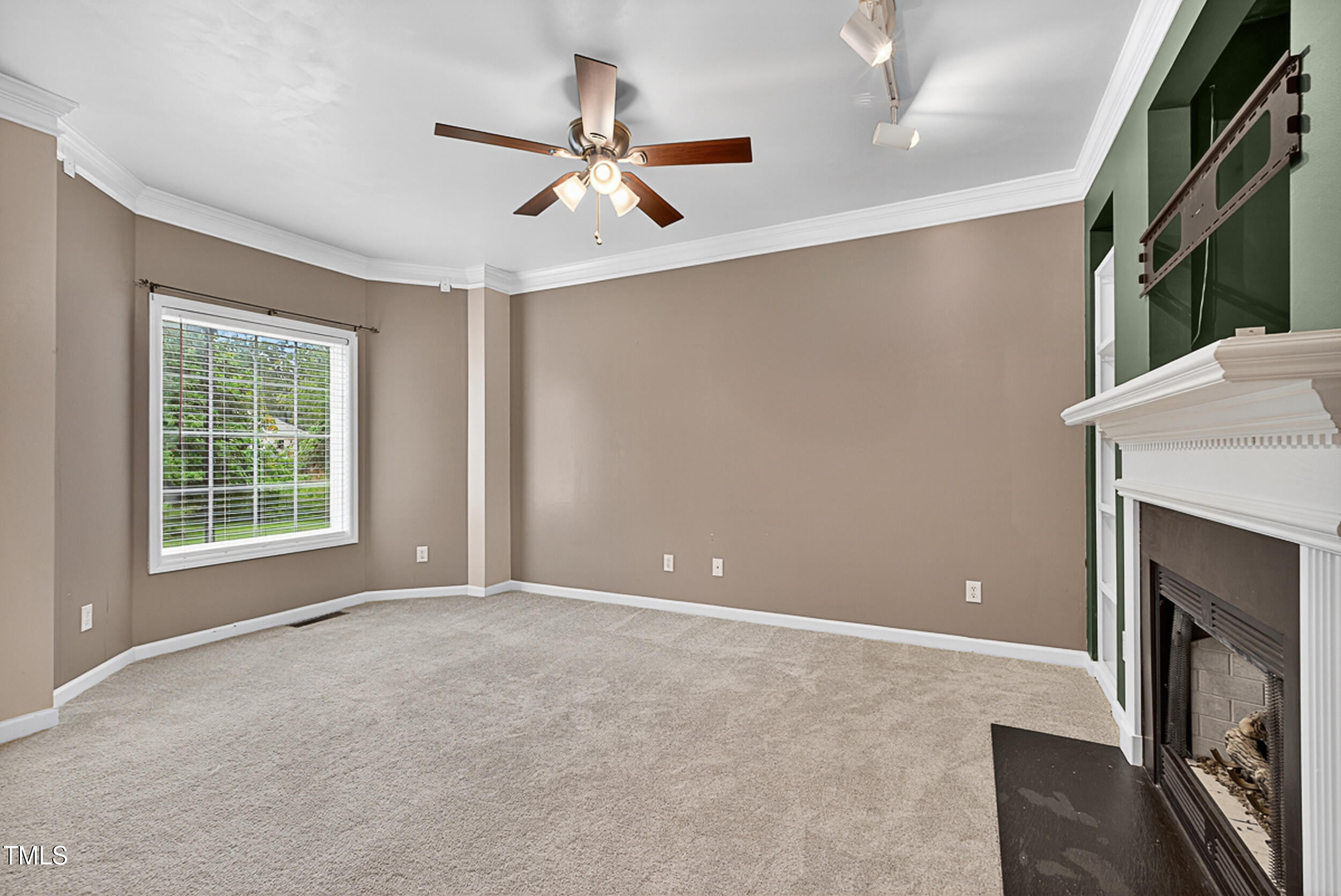 2407 Trout Stream Drive Raleigh, NC 27604 - Photo 4 of 24 a view of an empty room with a fireplace and a window