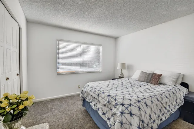 a bedroom with a bed and a chair