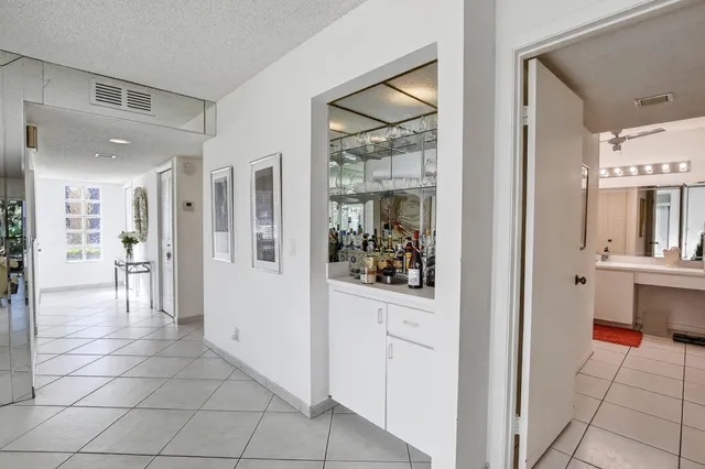 a living room with furniture a chandelier and a dining table