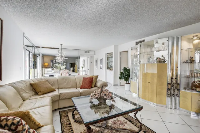 a living room with furniture and a chandelier