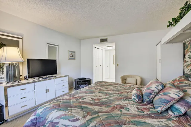 a view of walk in closet with clothes