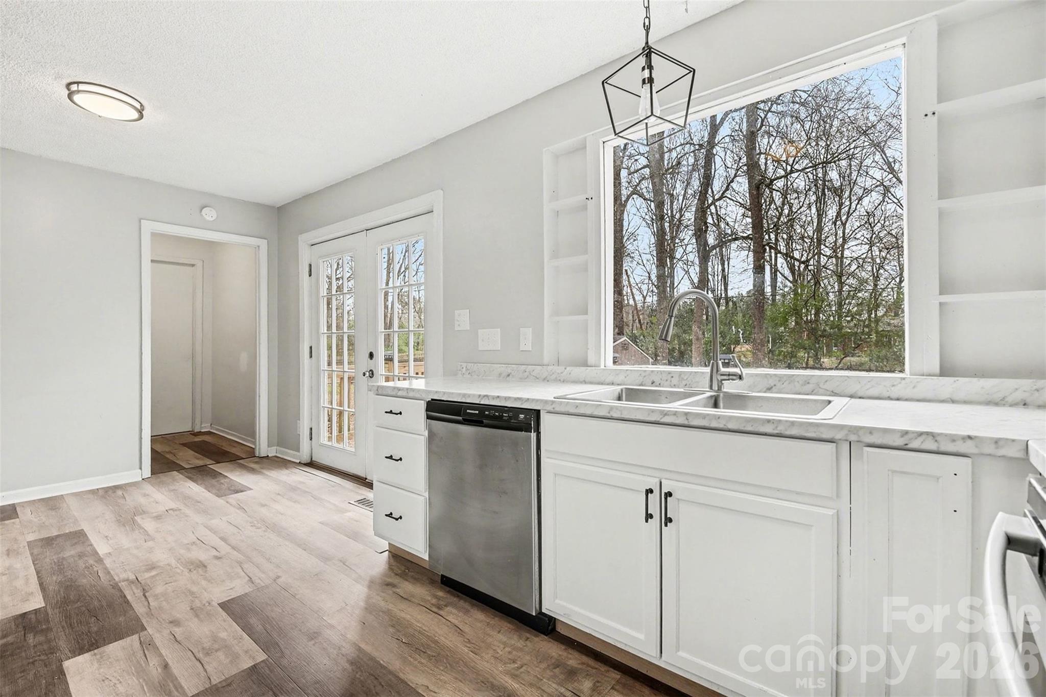 8011 Beacon Hills Road Indian Trail, NC 28079 - Photo 12 of 31 a kitchen with white cabinets and sink