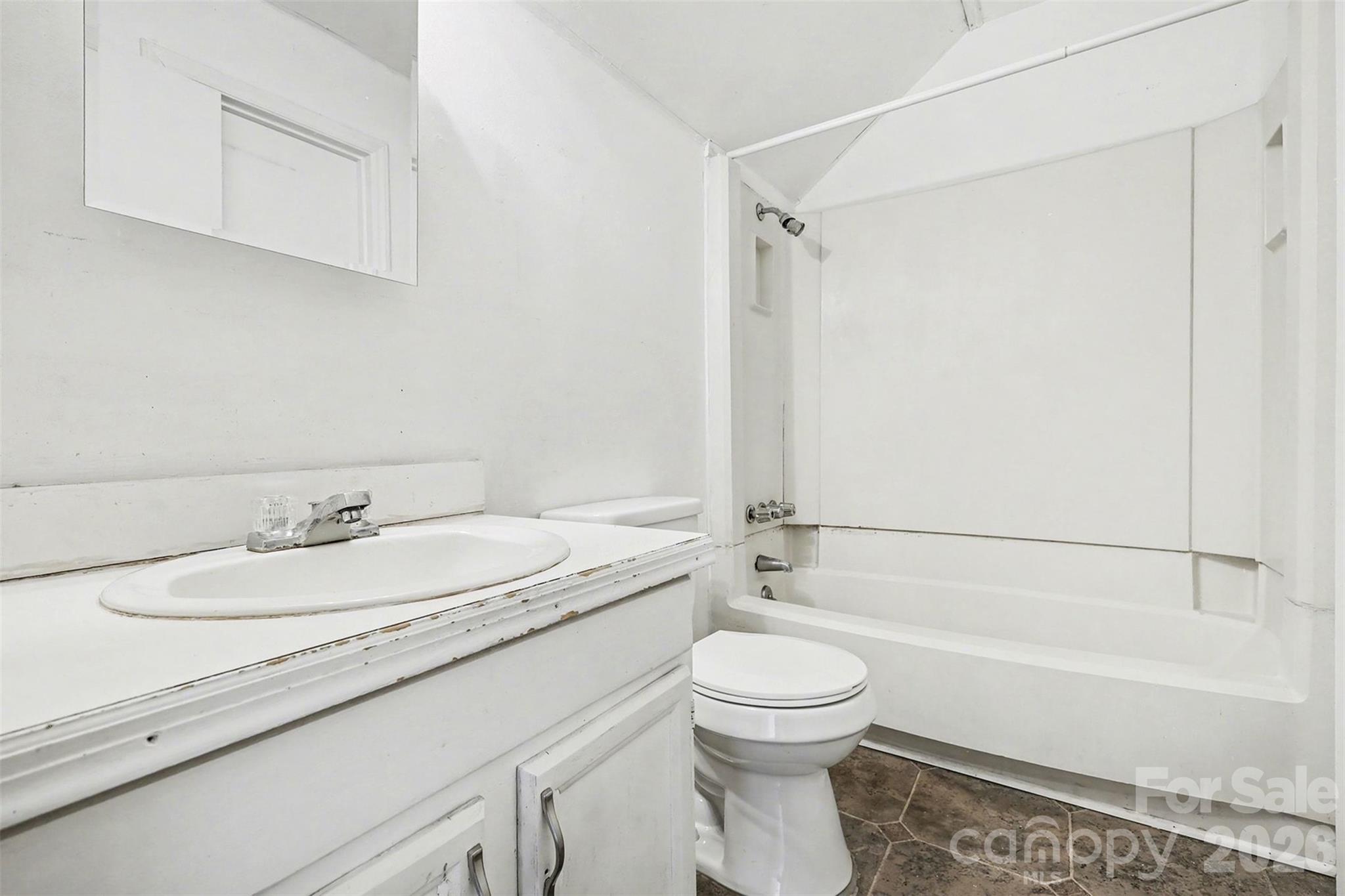 8011 Beacon Hills Road Indian Trail, NC 28079 - Photo 18 of 31 a bathroom with a granite countertop bathtub shower sink vanity and toilet