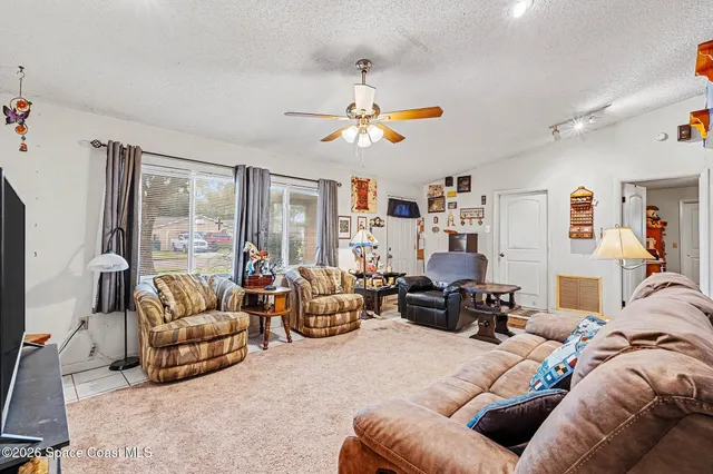 a living room with furniture a couch and a chandelier