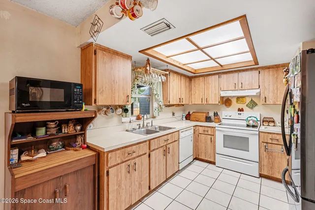 a kitchen with stainless steel appliances a stove sink and microwave