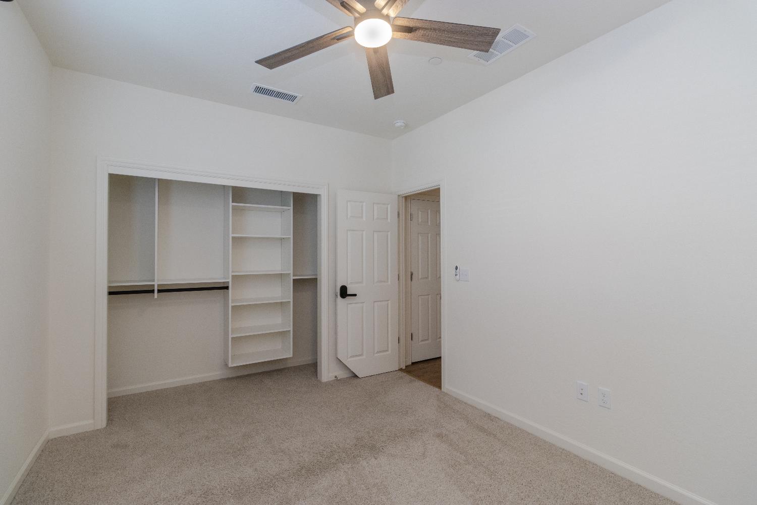 1158 Encore Way West Madera, CA 93636 - Photo 19 of 45 a view of an empty room with a ceiling fan