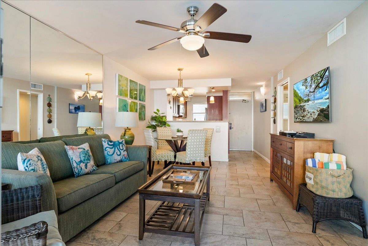 2430 South Kihei Road, Unit 206 Kihei, HI 96753 - Photo 11 of 40 a living room with furniture and a dining table with kitchen view
