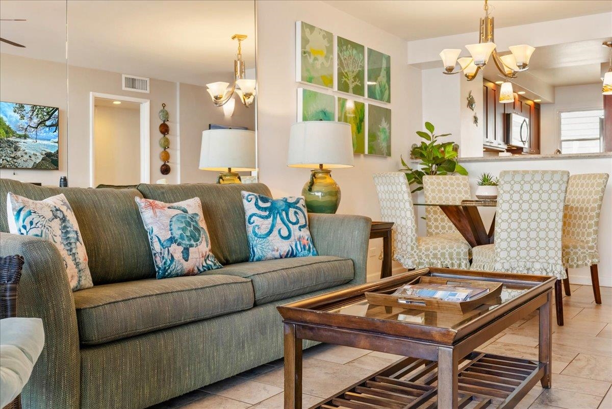 2430 South Kihei Road, Unit 206 Kihei, HI 96753 - Photo 12 of 40 a living room with furniture and a chandelier