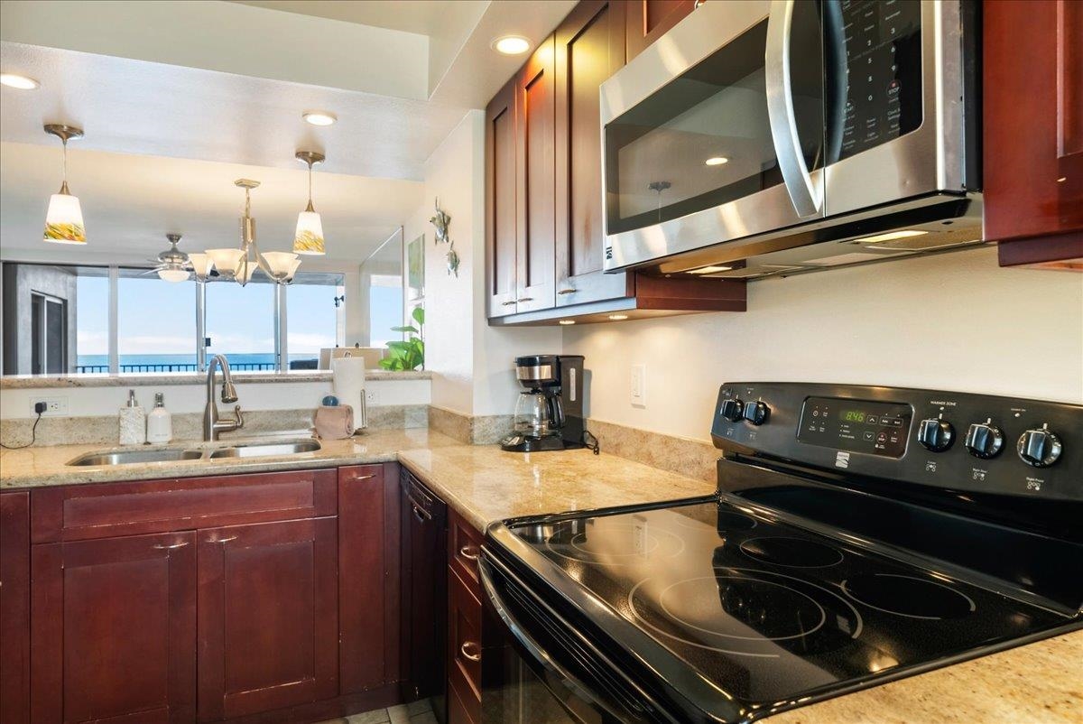 2430 South Kihei Road, Unit 206 Kihei, HI 96753 - Photo 14 of 40 a kitchen with a stove and a sink