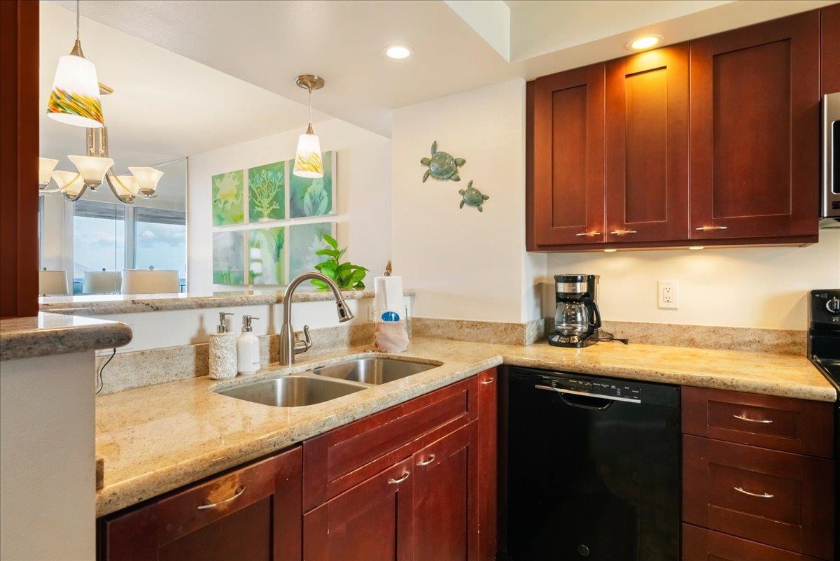 2430 South Kihei Road, Unit 206 Kihei, HI 96753 - Photo 15 of 40 a kitchen with a sink a window and cabinets