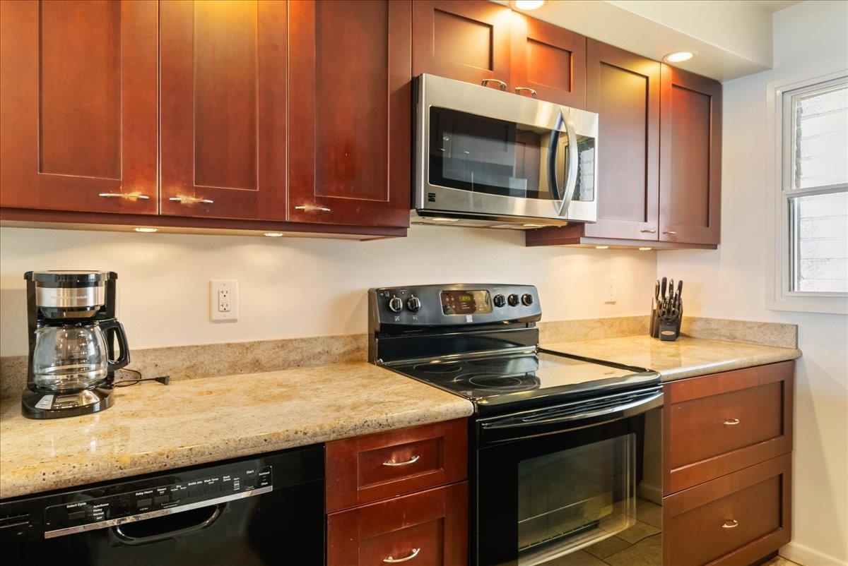 2430 South Kihei Road, Unit 206 Kihei, HI 96753 - Photo 16 of 40 a kitchen with granite countertop a stove and a sink