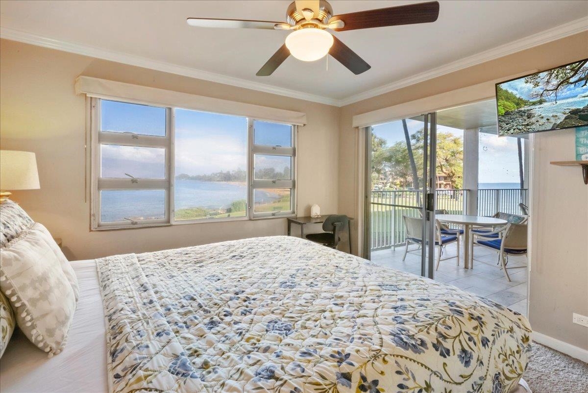 2430 South Kihei Road, Unit 206 Kihei, HI 96753 - Photo 17 of 40 a bedroom with a large bed and a chandelier