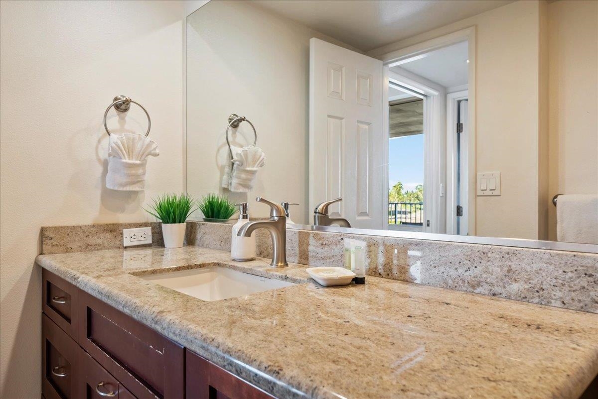 2430 South Kihei Road, Unit 206 Kihei, HI 96753 - Photo 21 of 40 a bathroom with a granite countertop sink and a mirror