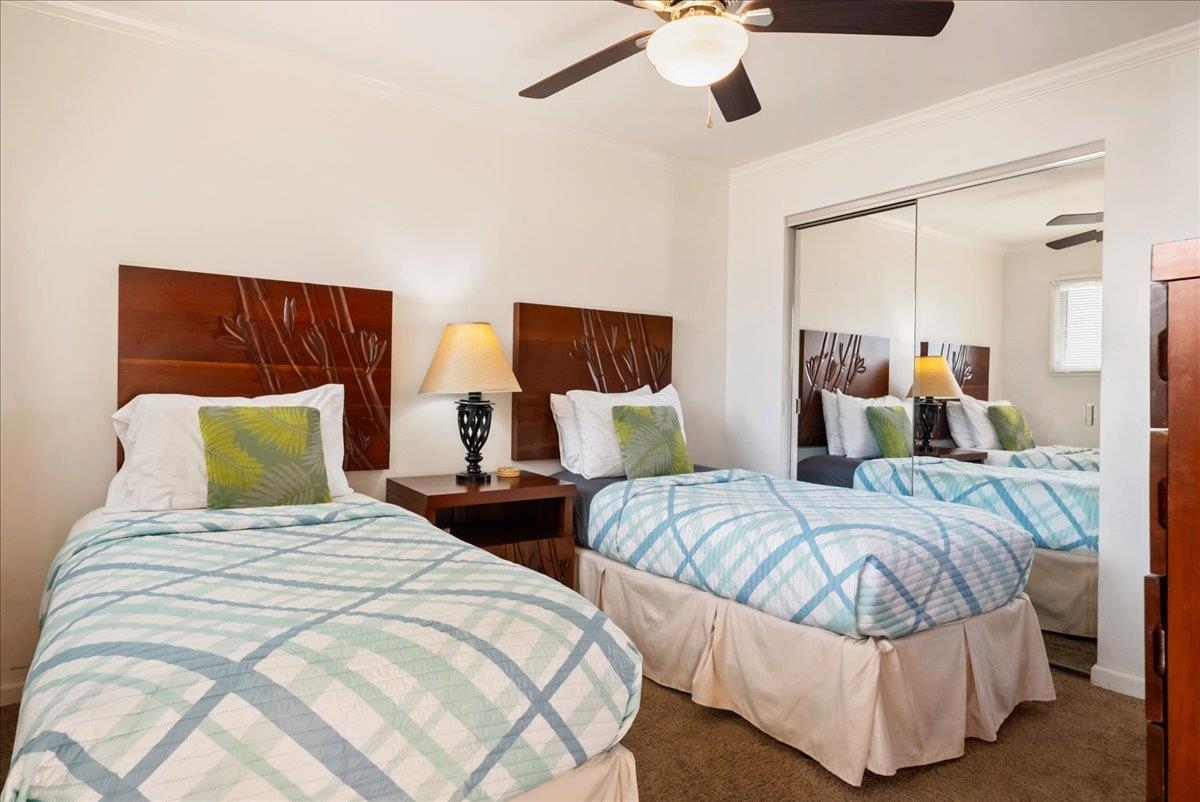 2430 South Kihei Road, Unit 206 Kihei, HI 96753 - Photo 23 of 40 a bedroom with two beds and painting on the wall