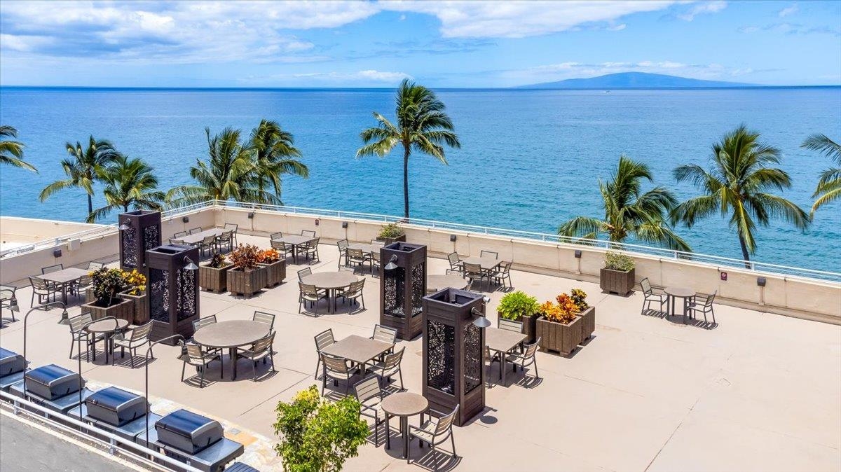 2430 South Kihei Road, Unit 206 Kihei, HI 96753 - Photo 31 of 40 a vase of flowers sitting on a table in front of a bathroom