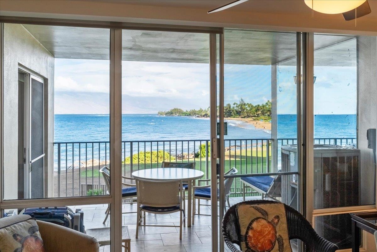 2430 South Kihei Road, Unit 206 Kihei, HI 96753 - Photo 6 of 40 a view of a balcony with furniture and wooden floor