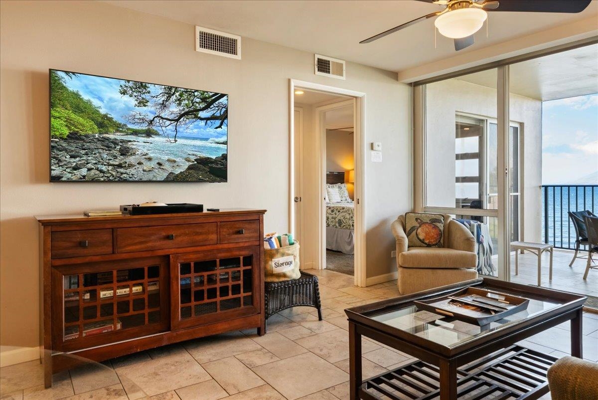 2430 South Kihei Road, Unit 206 Kihei, HI 96753 - Photo 7 of 40 a living room with furniture and a flat screen tv