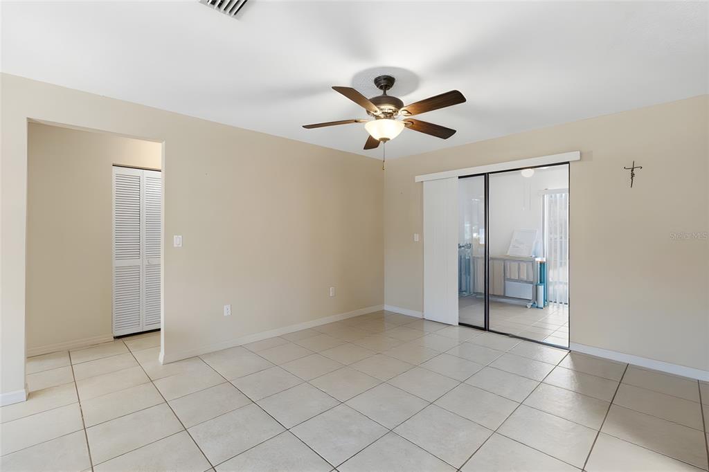 1437 Rommel Street Port Charlotte, FL 33952 - Photo 15 of 47 a view of an empty room and chandelier fan
