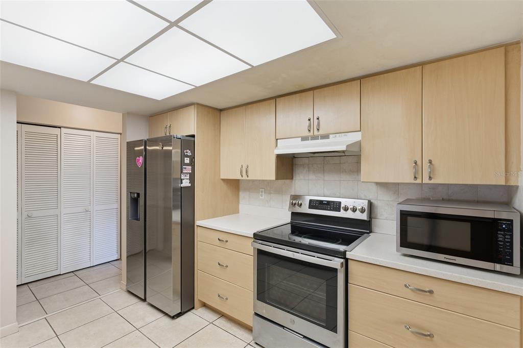1437 Rommel Street Port Charlotte, FL 33952 - Photo 16 of 47 a kitchen with stainless steel appliances granite countertop a refrigerator stove and cabinets