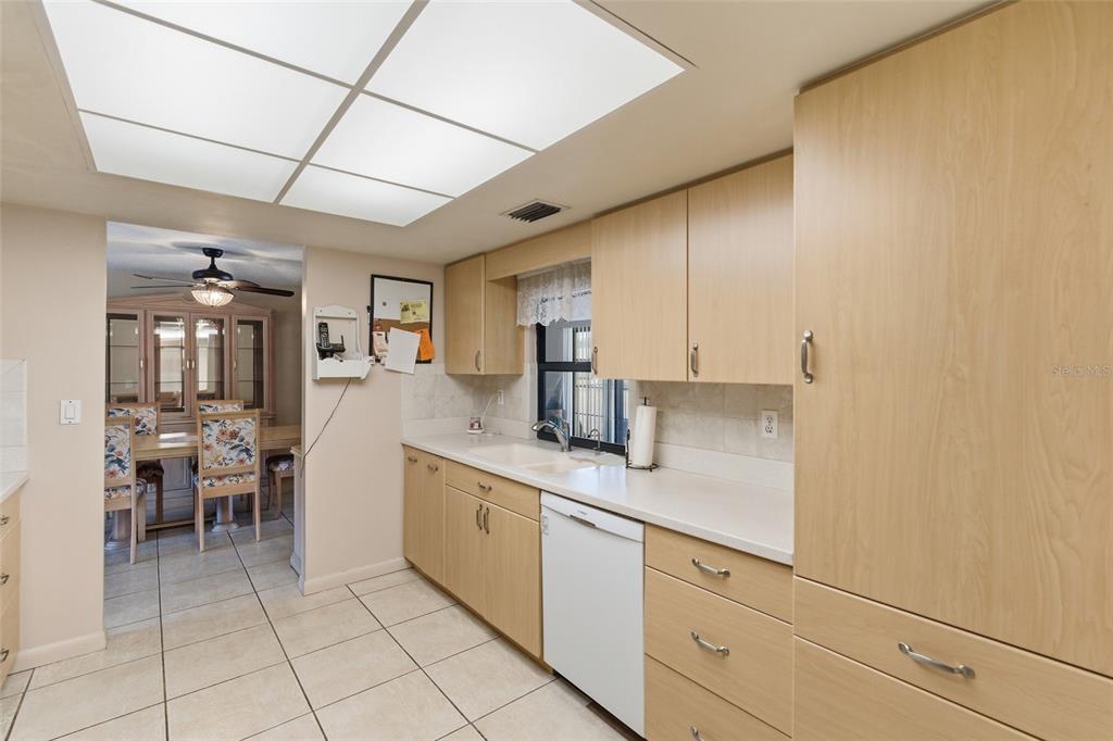 1437 Rommel Street Port Charlotte, FL 33952 - Photo 17 of 47 a kitchen with cabinets and chairs