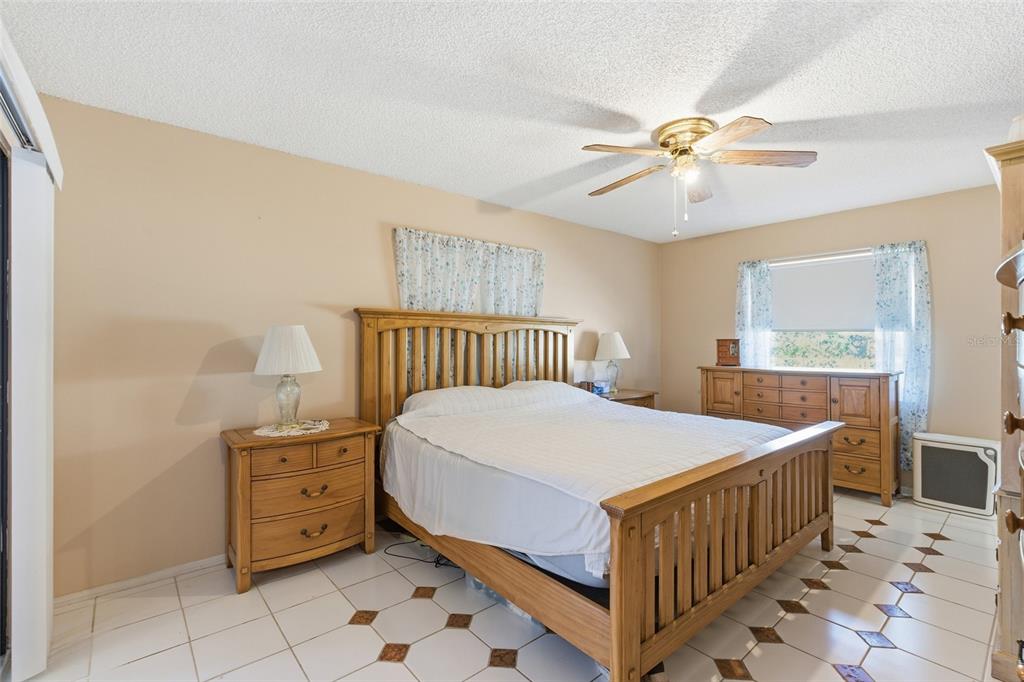 1437 Rommel Street Port Charlotte, FL 33952 - Photo 18 of 47 a bedroom with a bed and a chandelier