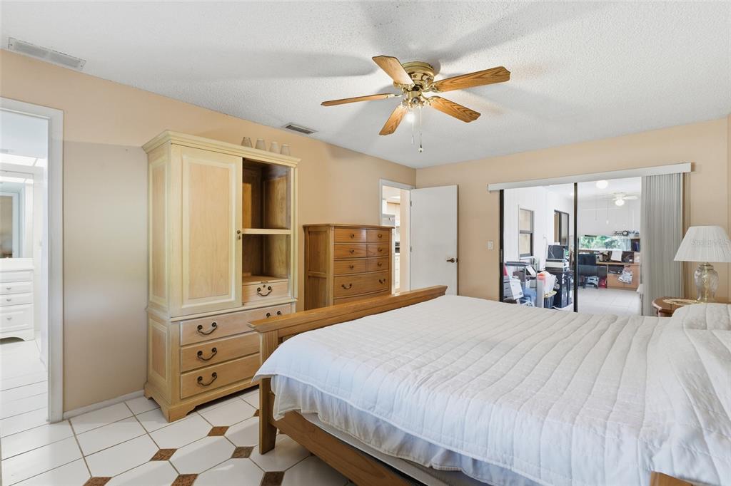 1437 Rommel Street Port Charlotte, FL 33952 - Photo 19 of 47 a bedroom with a bed and wooden floor