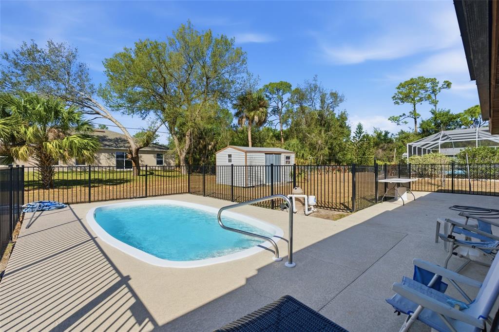 1437 Rommel Street Port Charlotte, FL 33952 - Photo 2 of 47 a view of a swimming pool with a patio