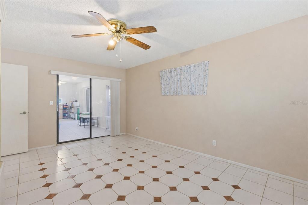 1437 Rommel Street Port Charlotte, FL 33952 - Photo 21 of 47 a view of a livingroom with wooden floor and a ceiling fan