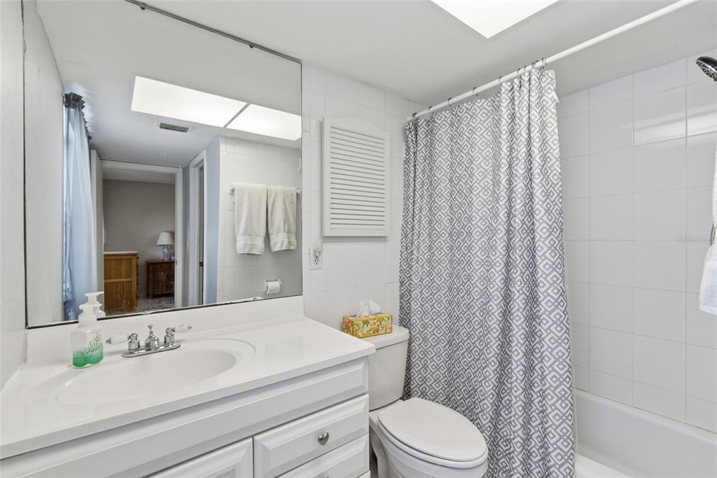 1437 Rommel Street Port Charlotte, FL 33952 - Photo 22 of 47 a bathroom with a sink a toilet and shower curtain