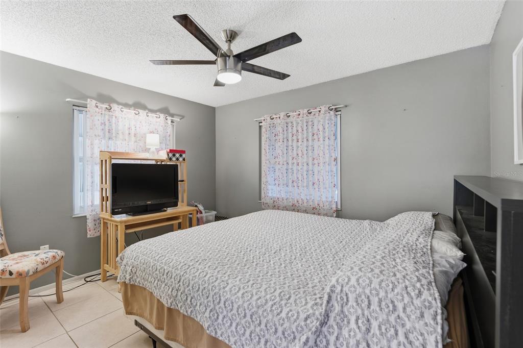 1437 Rommel Street Port Charlotte, FL 33952 - Photo 23 of 47 a bedroom with a bed and a flat screen tv