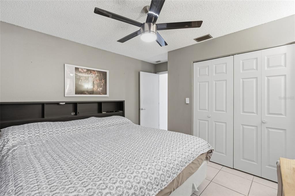 1437 Rommel Street Port Charlotte, FL 33952 - Photo 25 of 47 a large bedroom with a bed and a chandelier