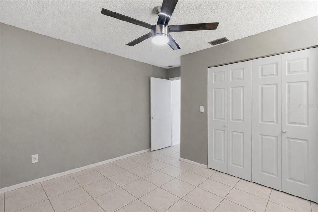 1437 Rommel Street Port Charlotte, FL 33952 - Photo 26 of 47 an empty room with fan