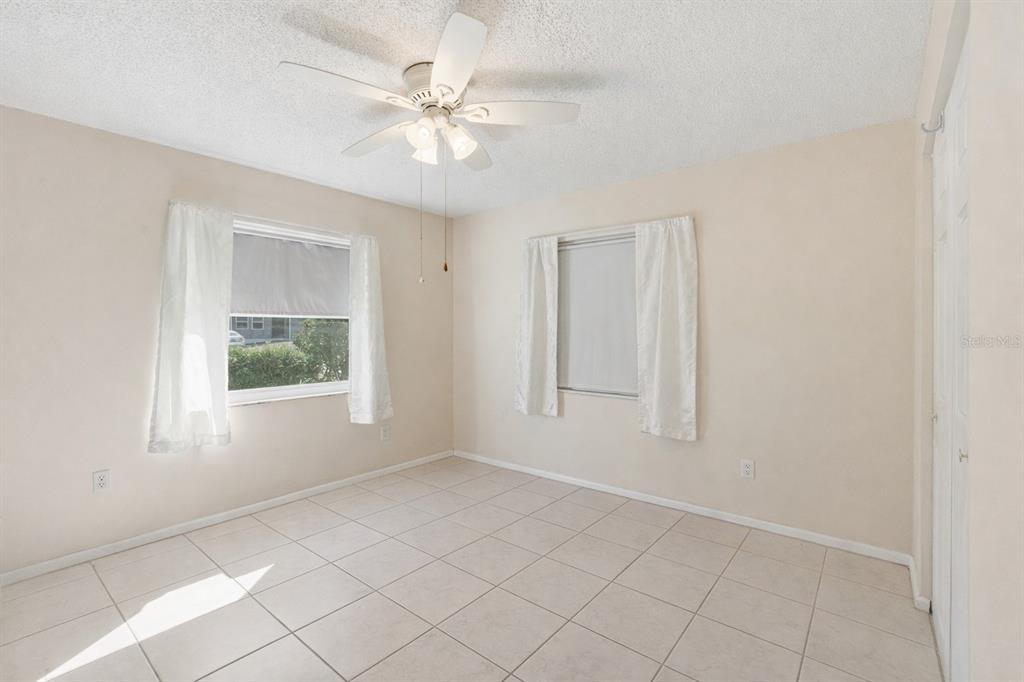 1437 Rommel Street Port Charlotte, FL 33952 - Photo 29 of 47 an empty room with windows and fan