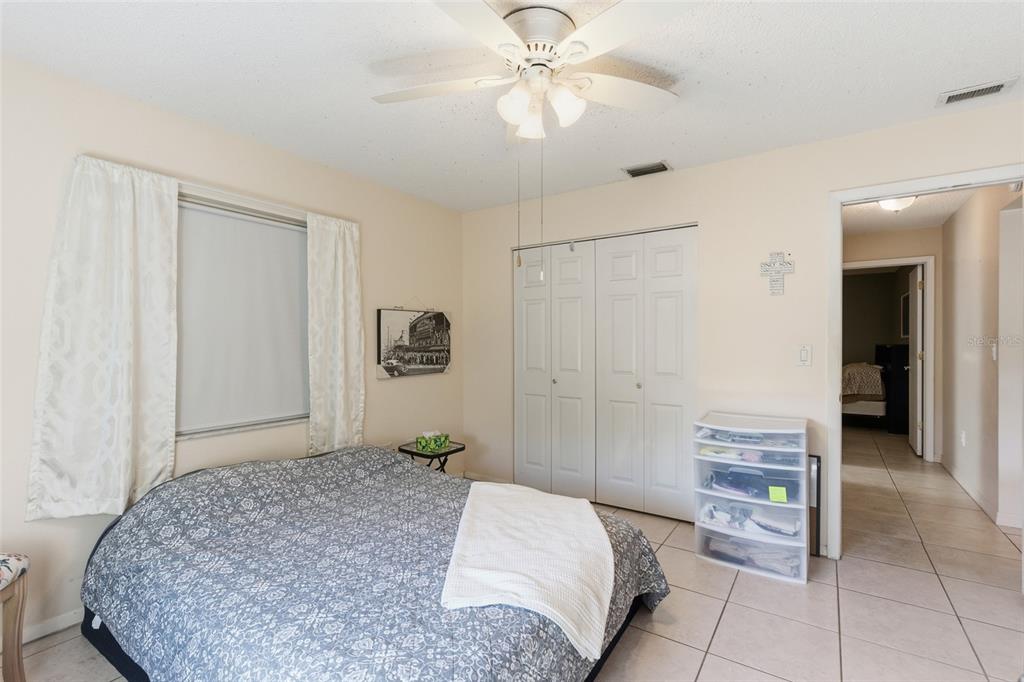 1437 Rommel Street Port Charlotte, FL 33952 - Photo 30 of 47 a bedroom with a bed and a chandelier