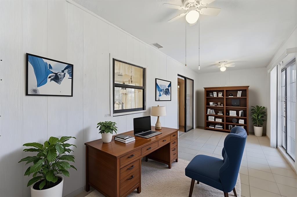 1437 Rommel Street Port Charlotte, FL 33952 - Photo 35 of 47 a living room with furniture potted plant and a window