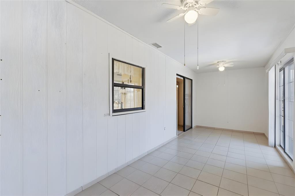 1437 Rommel Street Port Charlotte, FL 33952 - Photo 36 of 47 a view of an empty room with a chandelier fan