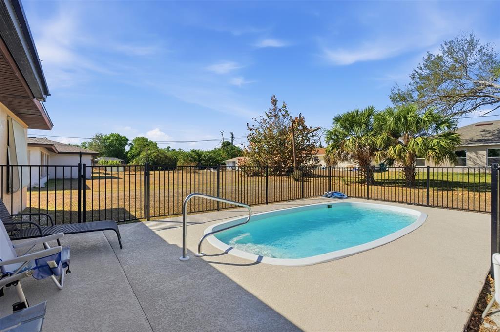 1437 Rommel Street Port Charlotte, FL 33952 - Photo 42 of 47 a view of a swimming pool with a lounge chair