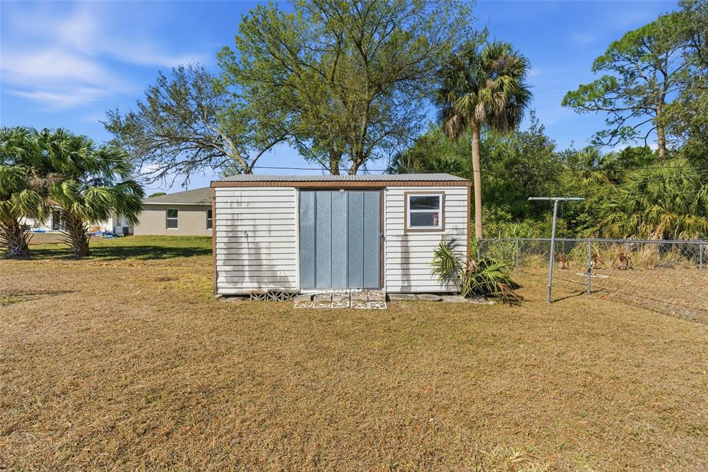 1437 Rommel Street Port Charlotte, FL 33952 - Photo 45 of 47 a view of a house with a yard and garage
