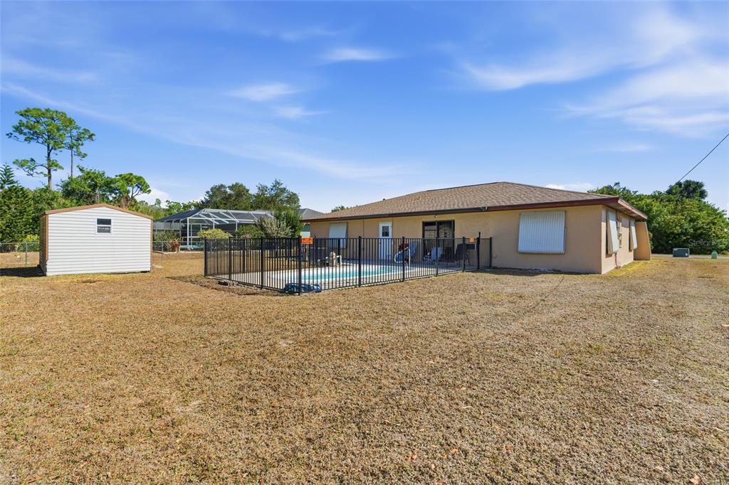 1437 Rommel Street Port Charlotte, FL 33952 - Photo 46 of 47 a front view of a house with a yard and a garage