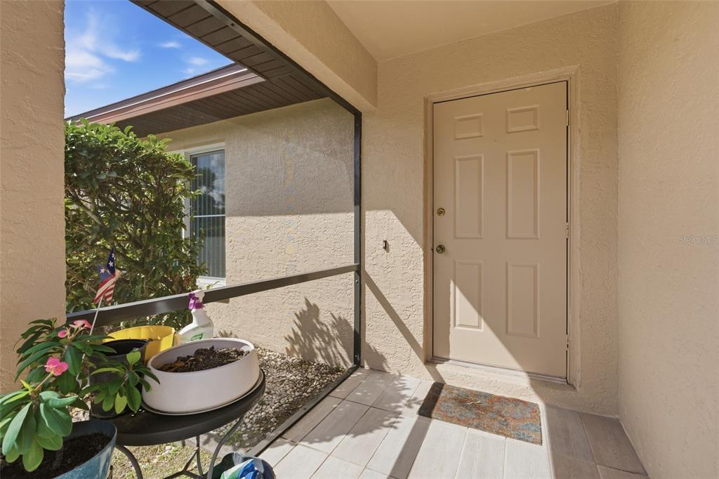 1437 Rommel Street Port Charlotte, FL 33952 - Photo 5 of 47 a living room with furniture and a potted plant