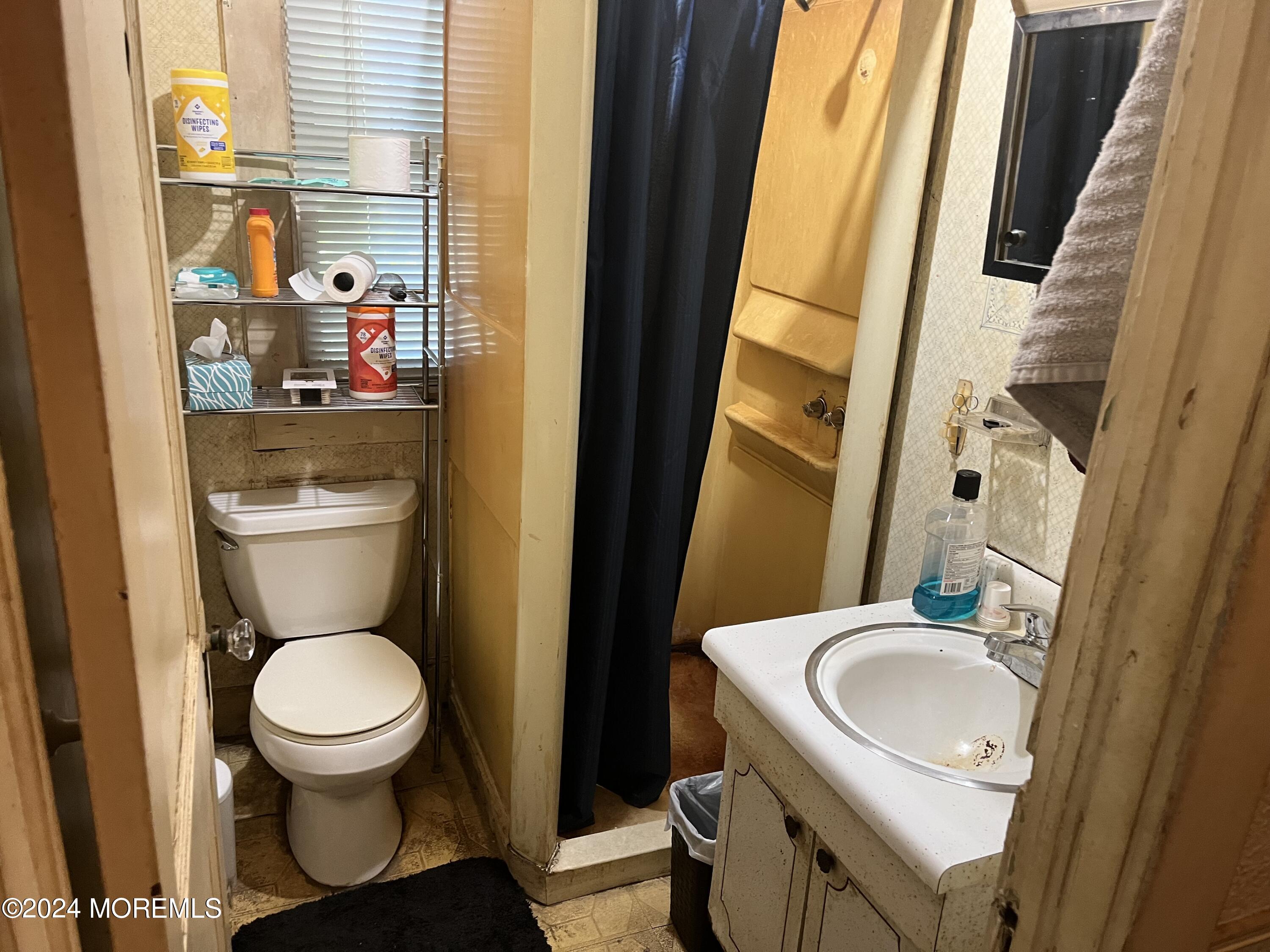 23 Robbins Road North Millstone Township, NJ 08535 - Photo 9 of 12 a bathroom with a sink a toilet and a mirror