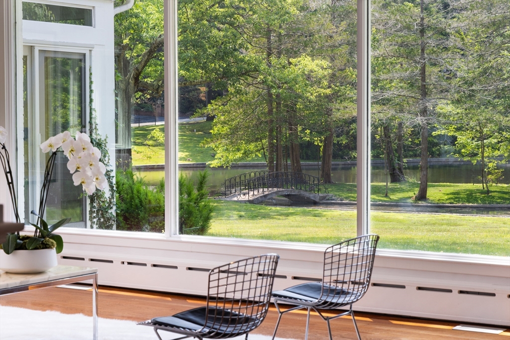 45 Cliff Road Weston, MA 02493 - Photo 11 of 26 a view of a chairs and table in the patio with a swimming pool