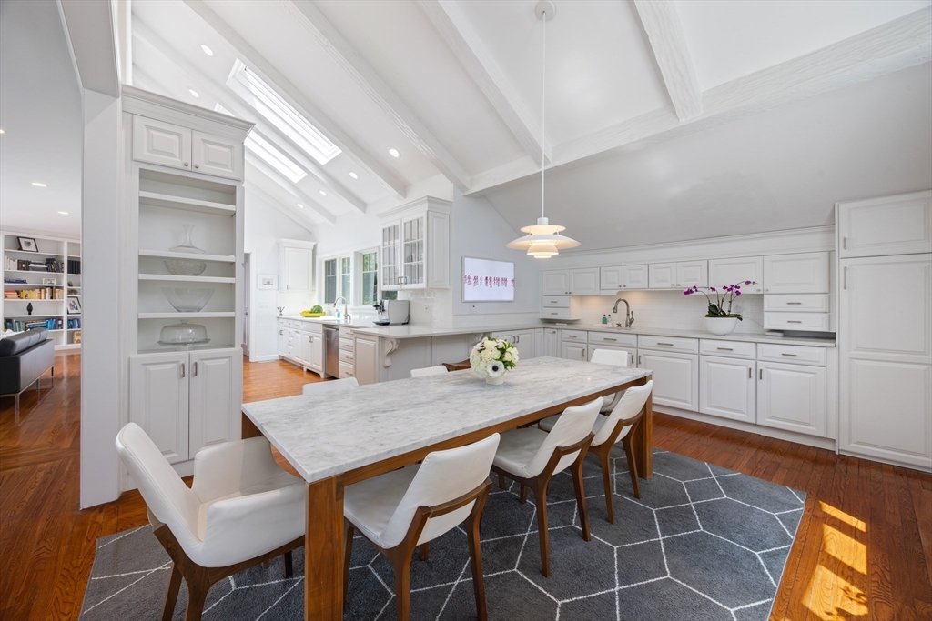 45 Cliff Road Weston, MA 02493 - Photo 5 of 26 a kitchen with a dining table chairs and white cabinets