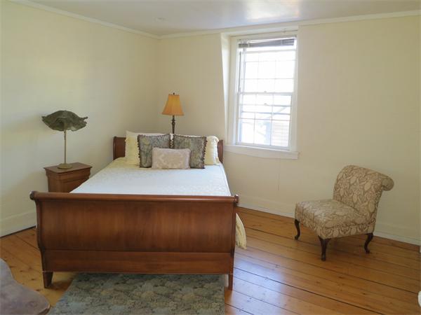 1 Rice Circle Cambridge, MA 02140 - Photo 9 of 18 a bedroom with a bed and a chair