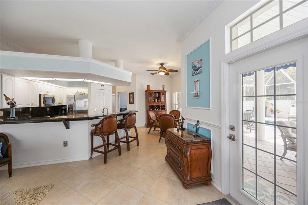 48 Bunker Road Rotonda West, FL 33947 - Photo 18 of 59 a living room with furniture a dining table and a large window