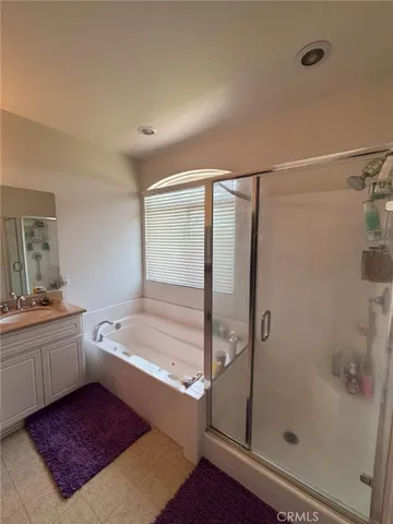 a bathroom with a tub sink and shower