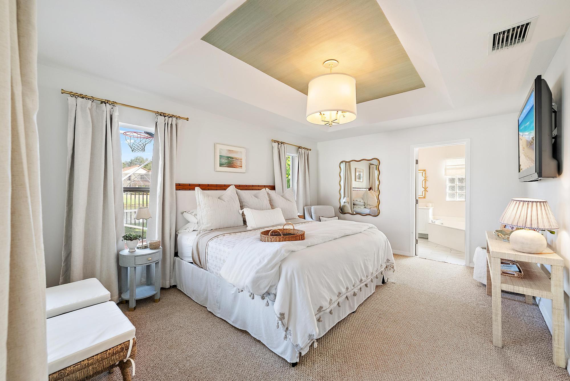 5010 Elpine Way Riviera Beach, FL 33418 - Photo 11 of 27 a bedroom with bed and a chandelier